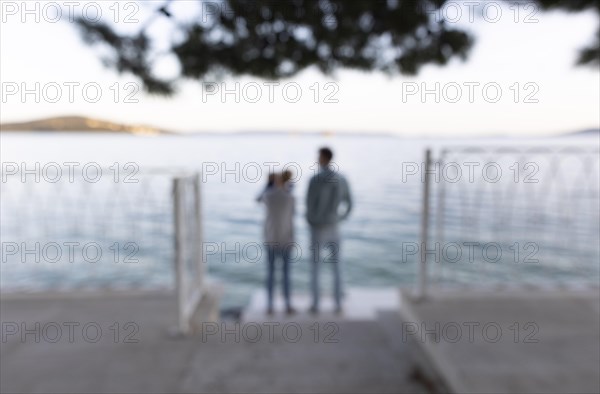 Family standing by the sea