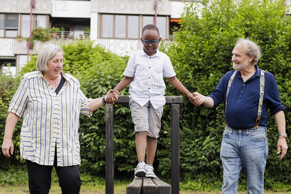 Grandparents on time. Grandparents with a boy on a playground.