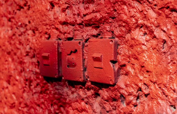 Red wall with old light switches