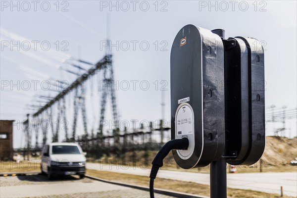 A charging pole in front of a substation at the company 50Hertz