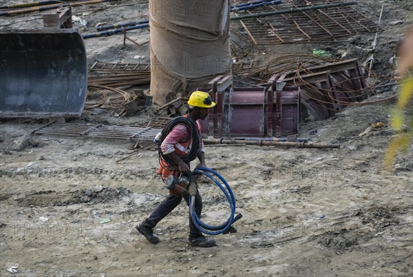 Construction workers busy build pillars of a bridge in the banks of Brahmaputra river on April 3