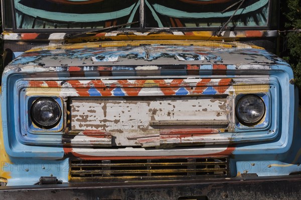 Front view of old safari jeep painted in multiple colours