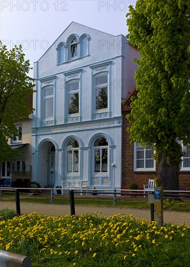 Old white villa at the harbour of Toenning