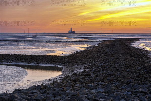 View from the Trischendamm to Germanys only drilling platform Mittelplate after sunset at low tide