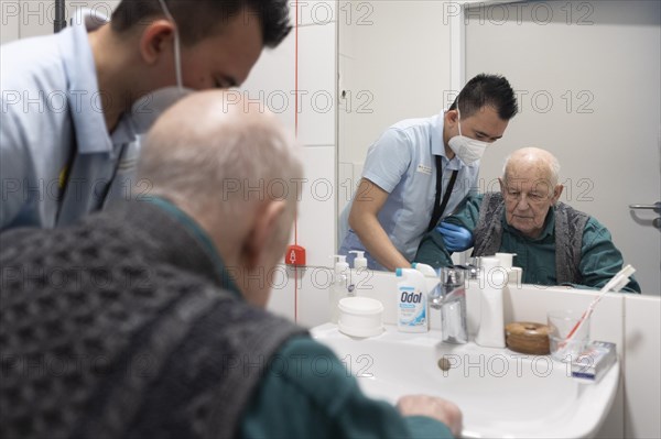 Caregiver and old man in a nursing home