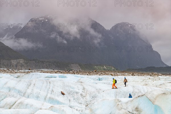 Hikers on the Exploradores glacier in the San Valentin massif