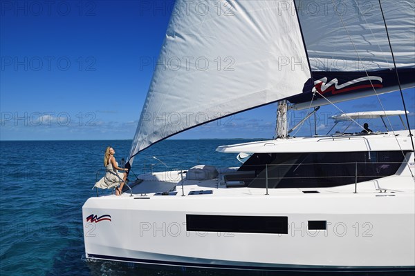 Woman enjoying the ride on a sailing catamaran