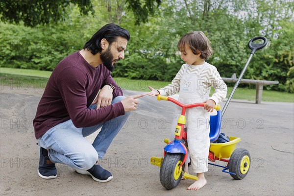 Father with child on a playground in the green