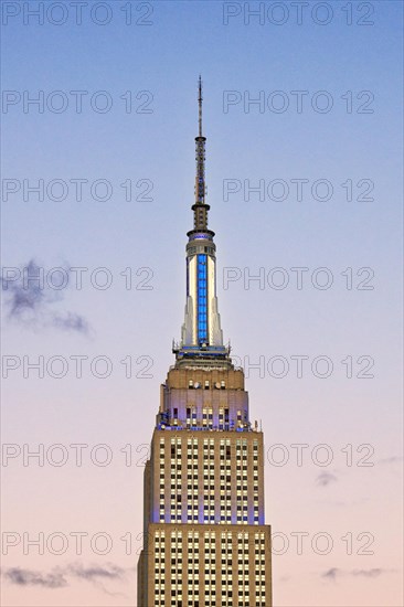 Empire State Building glows white-blue