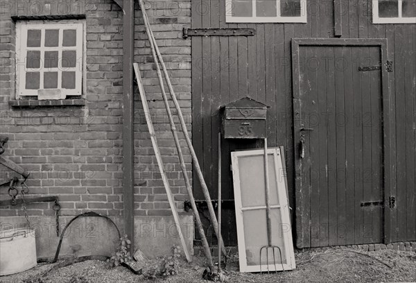 Garden tools leaned against a barn