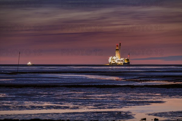 Germanys only oil rig Mittelplate at night and low tide