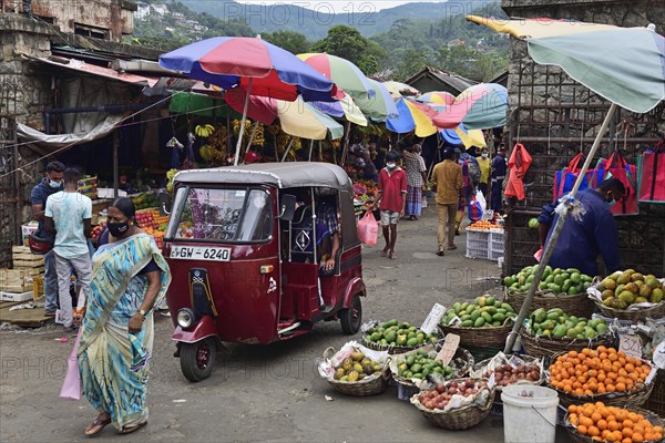 Fruit stalls and tuk tuk at the market