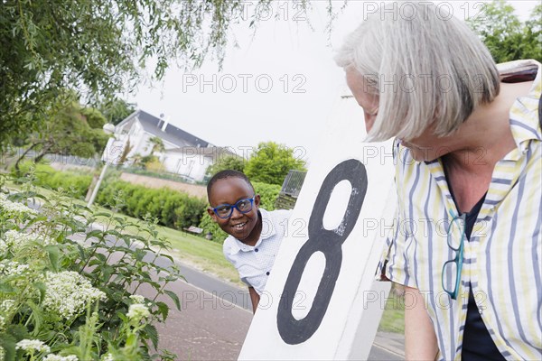 Temporary grandparents. Elderly couple volunteer to look after a boy from Africa for a few hours a week.