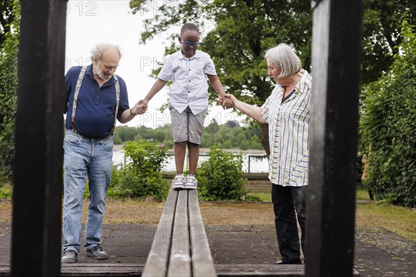 Grandparents on time. Grandparents with a boy on a playground.