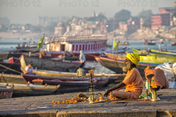 Spiritual morning prayer at the holy river Ganges in Varanasi