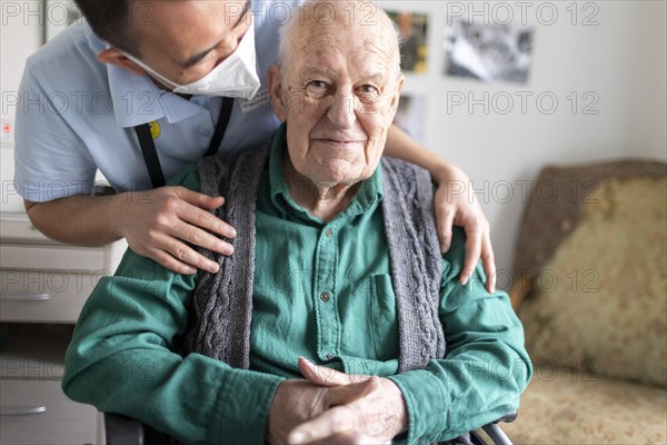 Geriatric nurse talking to a resident in a nursing home