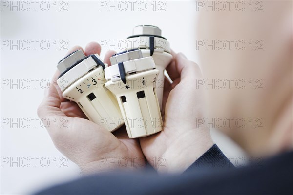 Symbolic photo on the subject of increased heating costs. Thermostats of radiators. Berlin