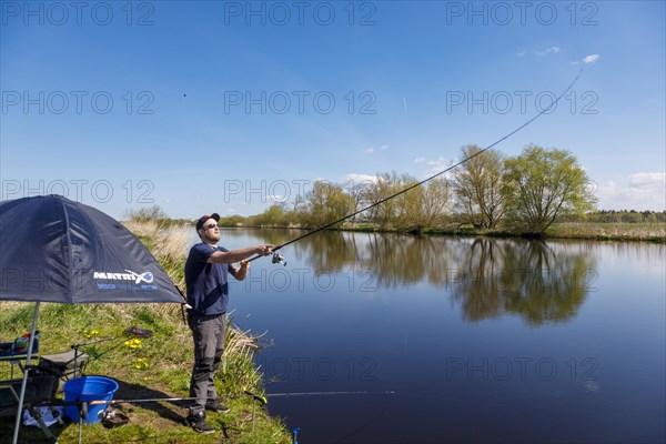 Angler at the Giselau Canal casts a rod