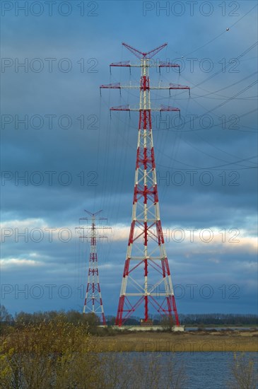 Red and white marked electricity pylons on the Lower Elbe near Stade
