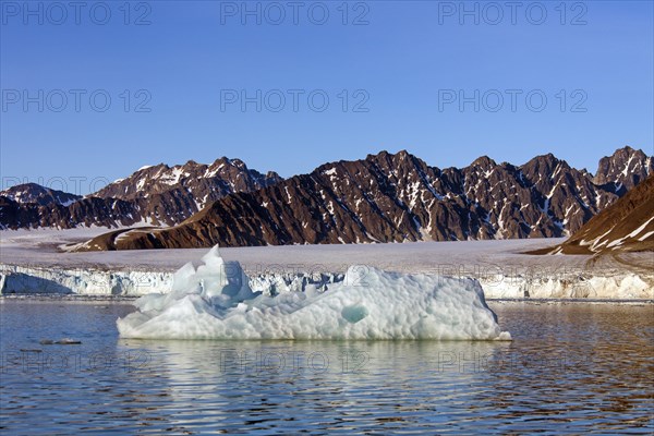 Calved iceberg from the Lilliehoeoekbreen glacier drifting in the Lilliehoeoekfjorden