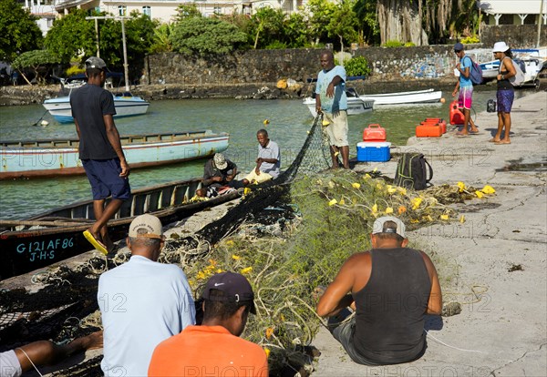 Fishermen on the quay wall