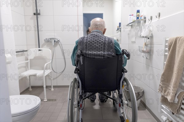 Old man alone in a disabled bathroom