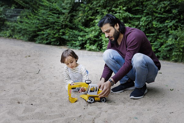 Father with child on a playground in the green