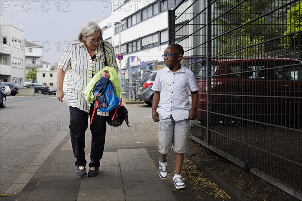 Temporary grandmother. Temporary grandmother cares for a boy from Africa for a few hours a week on a voluntary basis.