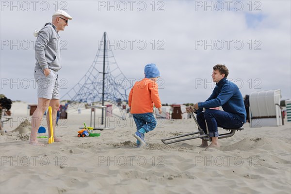 Subject: Toys for adults on the beach of Borkum. Three generations.