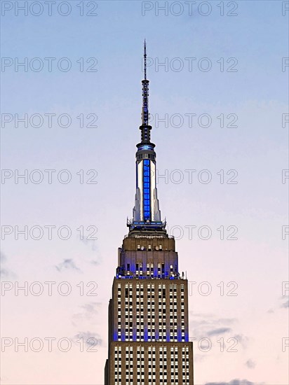 Empire State Building glows white-blue