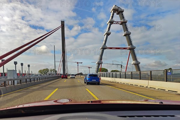 View from the car on the A1 motorway while driving over the old Rhine bridge with the new building next to it