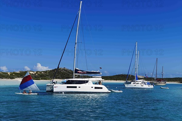 Sailboats and catamarans anchor off Warderick Wells