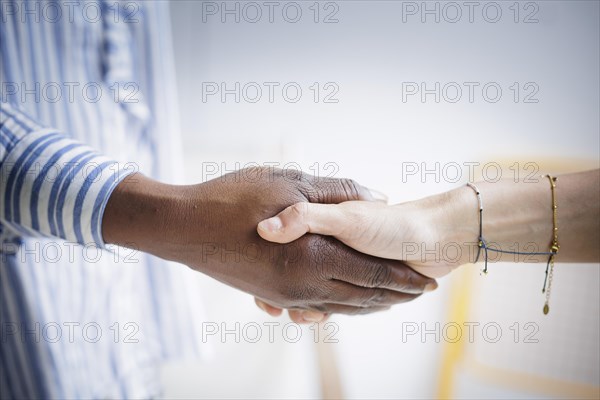 Two woman holding hands