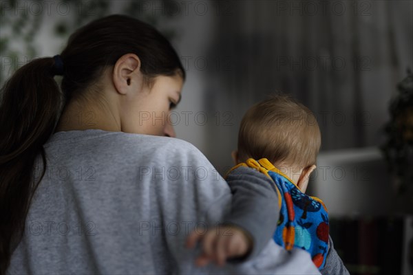 Girl with baby in her arms