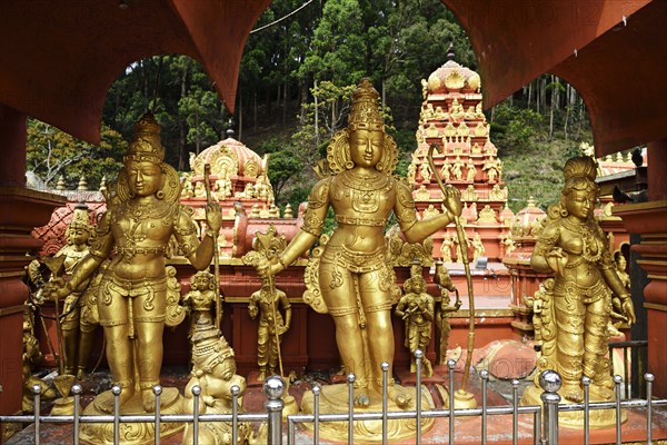 Three golden statues of gods