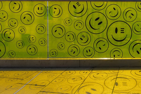 Yellow plastic wall with smileys