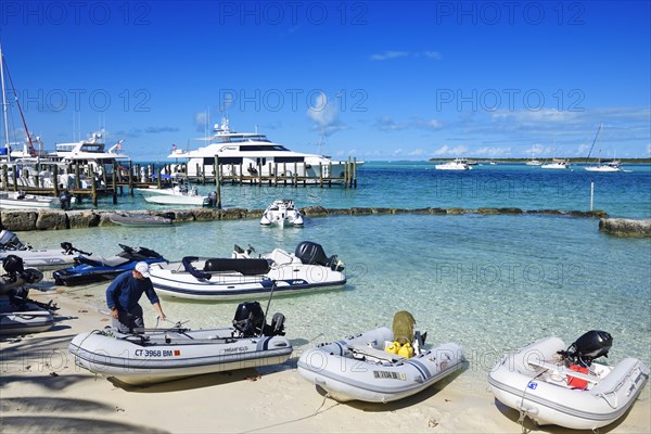 Dinghies on the beach and sailing yachts in the harbour of Staniel Cay