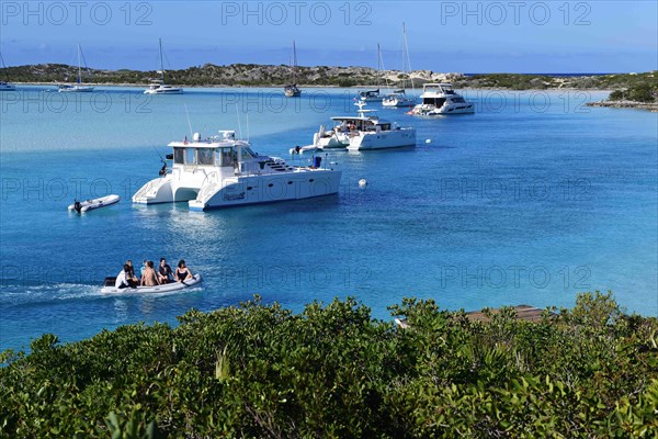 Sailboats and catamarans anchor off Warderick Wells