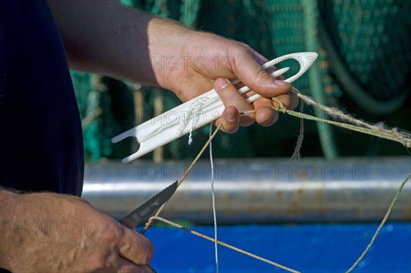 Fishermen mending nets