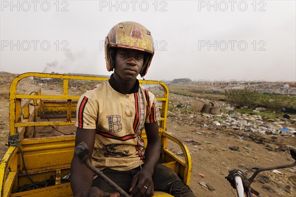 Young man at the textile dump in Accra