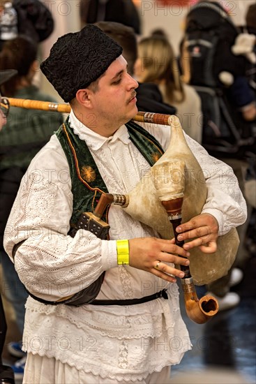 Folk musicians of the Kukeri in traditional traditional costume with bagpipes