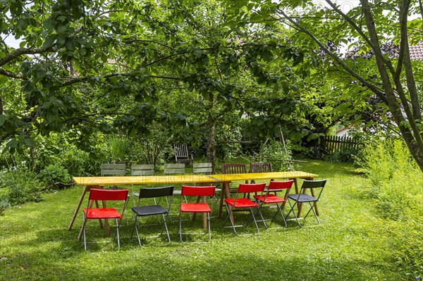 Table and colourful chairs in a garden