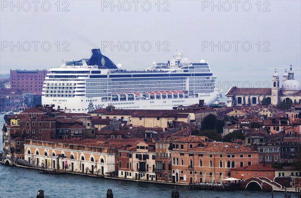 The cruise ship MSC Musica of the shipping company MSC Cruises sails to the cruise terminal Stazione Marittima. Meanwhile