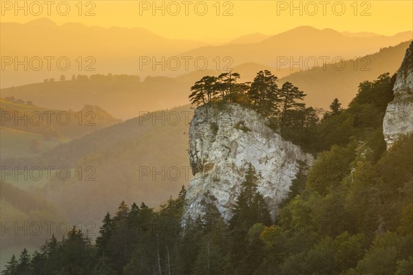 Golden evening light over the striking rocky head of Ankenballen and the chains of hills behind it in the canton of Basel-Landschaft