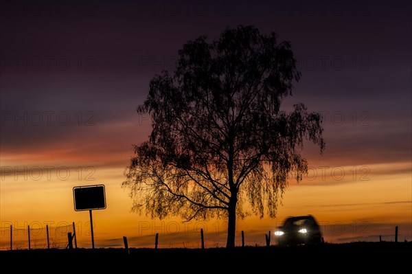 A car stands out in the evening twilight near Ober-Prauske