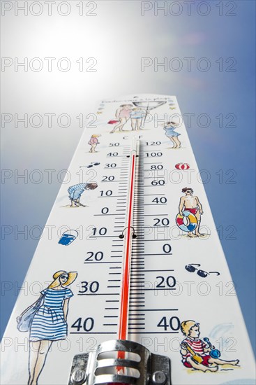 Worm's-eye view of thermometer measures extremely hot temperature of 40 degrees Celsius