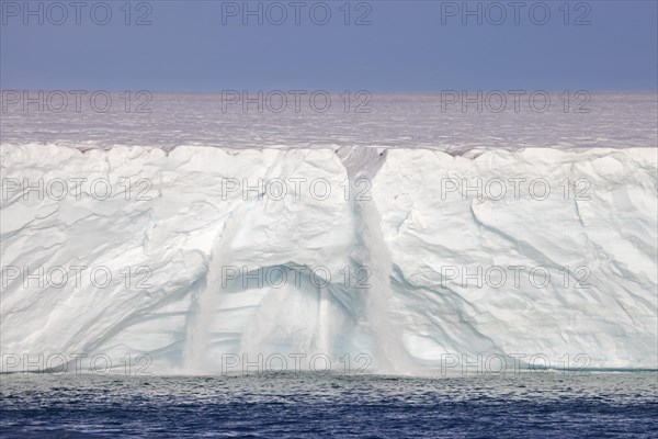 Waterfalls at edge of the Brasvellbreen glacier from the ice cap Austfonna debouching into the Barents Sea