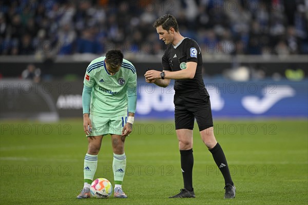 Referee Referee Dr Matthias Joellenbeck shows Rodrigo Zalazar FC Schalke 04 S04