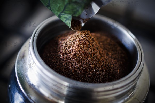 Symbolic photo on the subject of coffee. Ground coffee lies in an espresso machine. Berlin