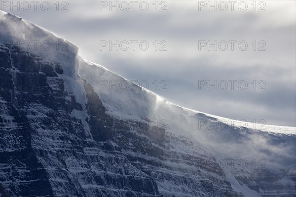 Snow blowing over cornices during snowstorm over Mount Kitchener